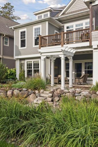 A closer view of the rear architecture and the homeâs connection to the creekside gardens.
