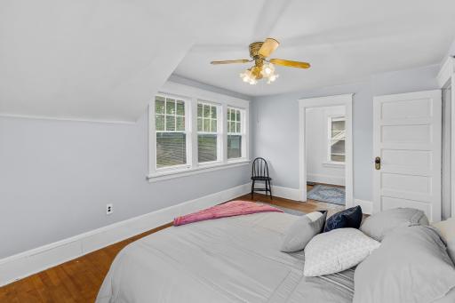 Large master bedroom offers hard wood floors, lots of natural light