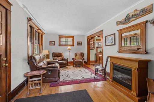Living room offers lots of natural light along with natural woodwork and hardwood floors