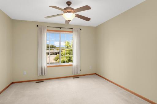 Primary bedroom with ceiling fan walks through to the bathroom.