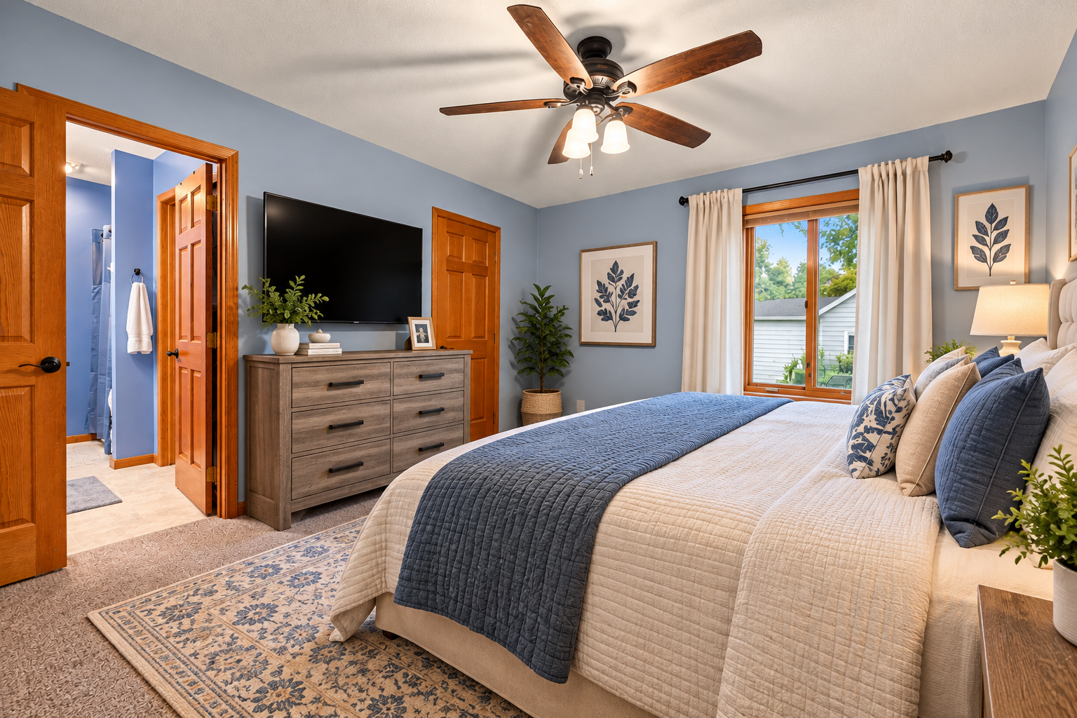 Spacious primary suite featuring a private bath, beautiful woodwork, and plenty of room to relax. Virtually Staged.