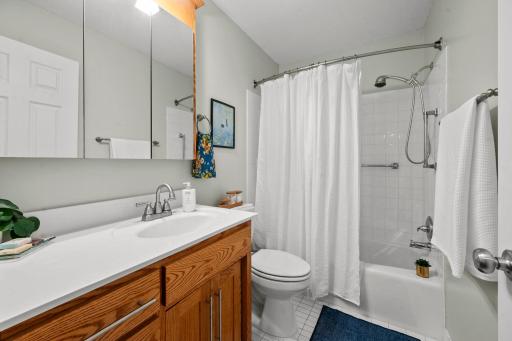 Fresh and bright bath features custom cabinetry and updated fixtures