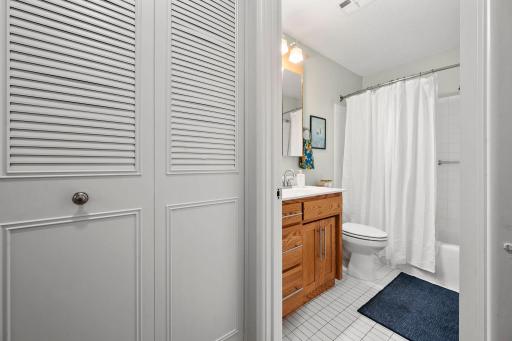 Fresh and bright full bath bath right off the BR with custom cabinetry and updated fixtures