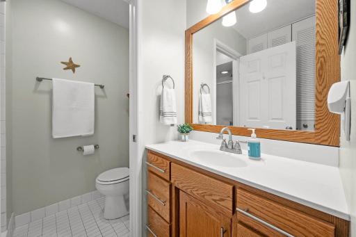 3/4 bath has updated fixtures and custom cabinetry