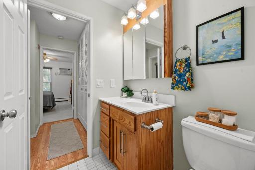 Fresh and bright bath right off the BR with custom cabinetry and updated fixtures