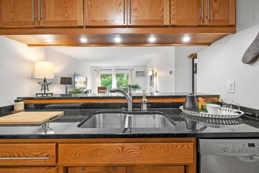 Kitchen features custom cabinetry and granite countertops.