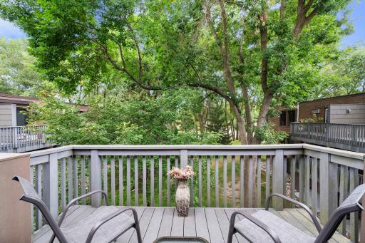 Deck overlooks the grounds with has tons of mature trees and lots of yard space