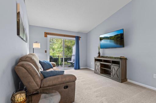 The upper level living room offers access to the deck that was replaced in 2022.