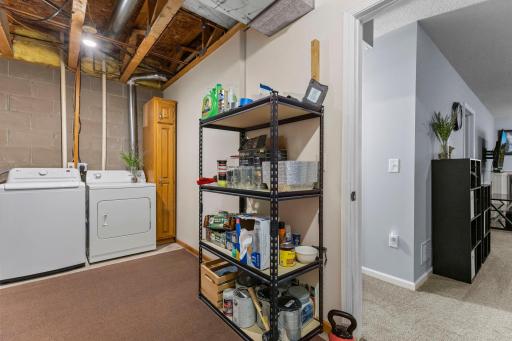The lower level laundry room has room for storage.