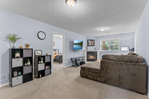 The lower level features a fireplace perfect for cozy evenings at home.
