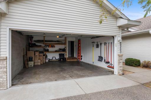 The 2-stall garage has an apron and storage racks.