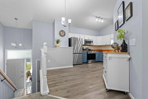 Kitchen updates include new flooring and painted cabinetry.