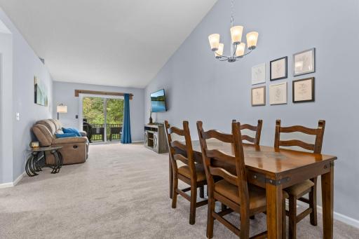 The upper level living room and dining room are open with views to the backyard.