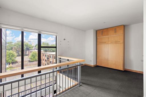 Open loft with floor to ceiling windows and a murphy bed