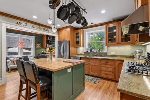 Custom cabinetry, stone counter tops, big center island for prep and seating with butcher block counter top