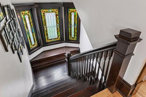 More stunning stained-glass window with bay seating at the landing.
