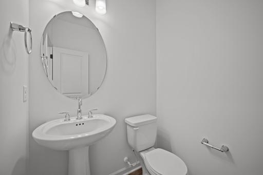 Main-level powder room in the McBee plan positioned for everyday convenience. Images are from a similar home, interior selections may differ