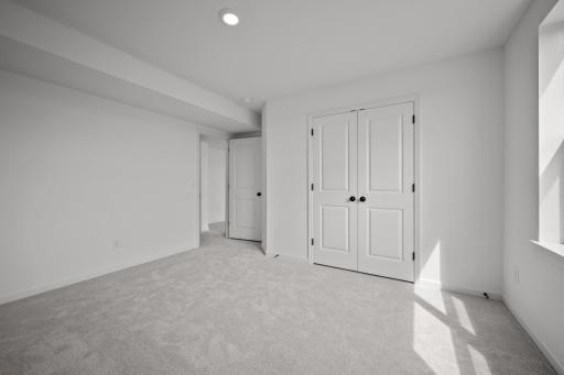Comfortable secondary bedroom in the McBee plan ideal for guests or family use. Images are from a similar home, interior selections may differ