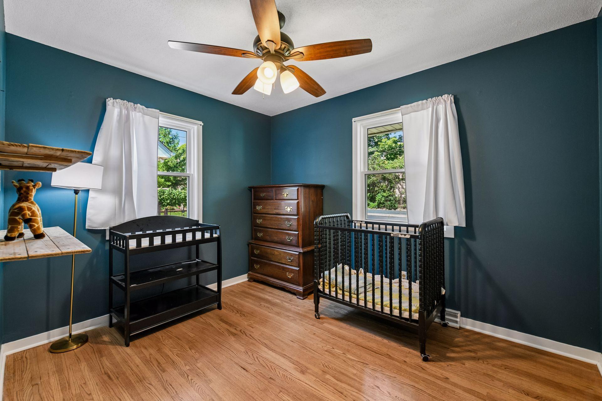 Bedroom with hardwood floor and dual windows