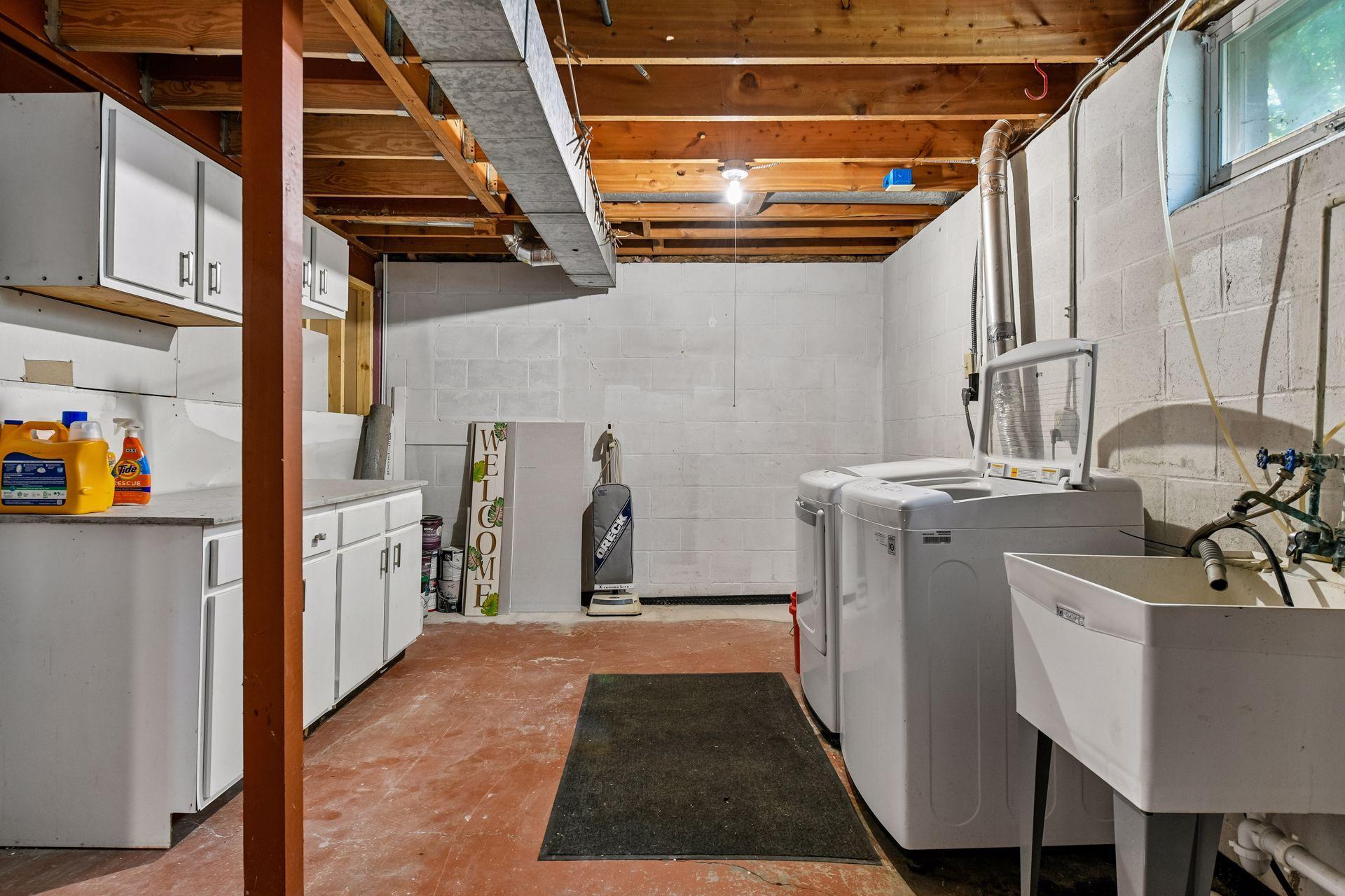 Lower level laundry area with utility sink