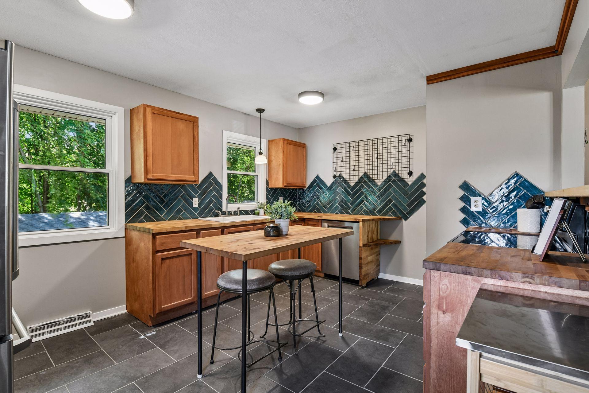 Enhanced kitchen with butcher block counters and chevron backsplash