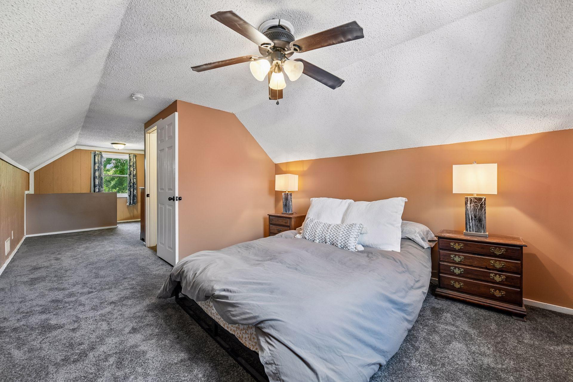 Bedroom with ceiling fan and adjacent closet