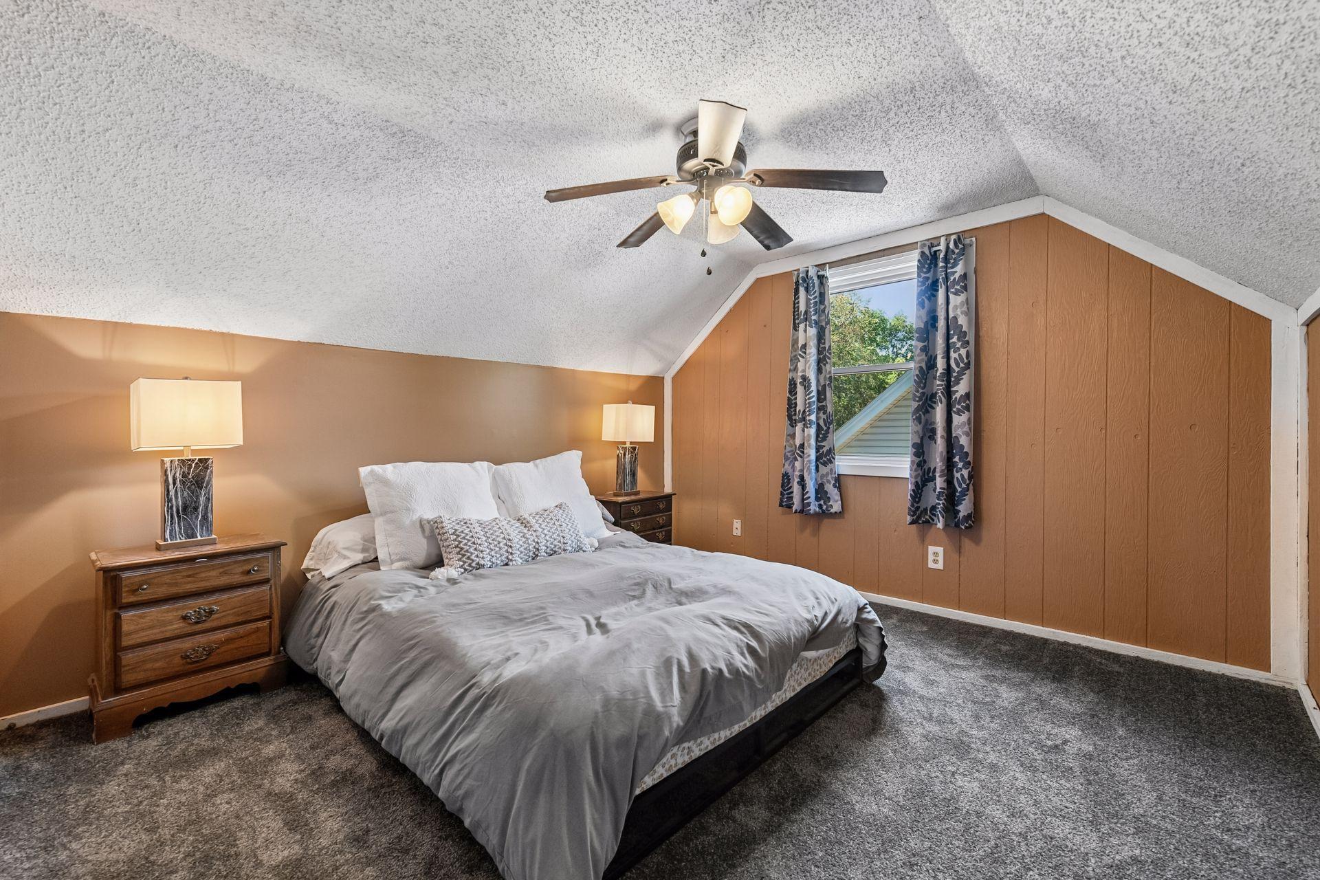 Bedroom with vaulted ceiling and ceiling fan