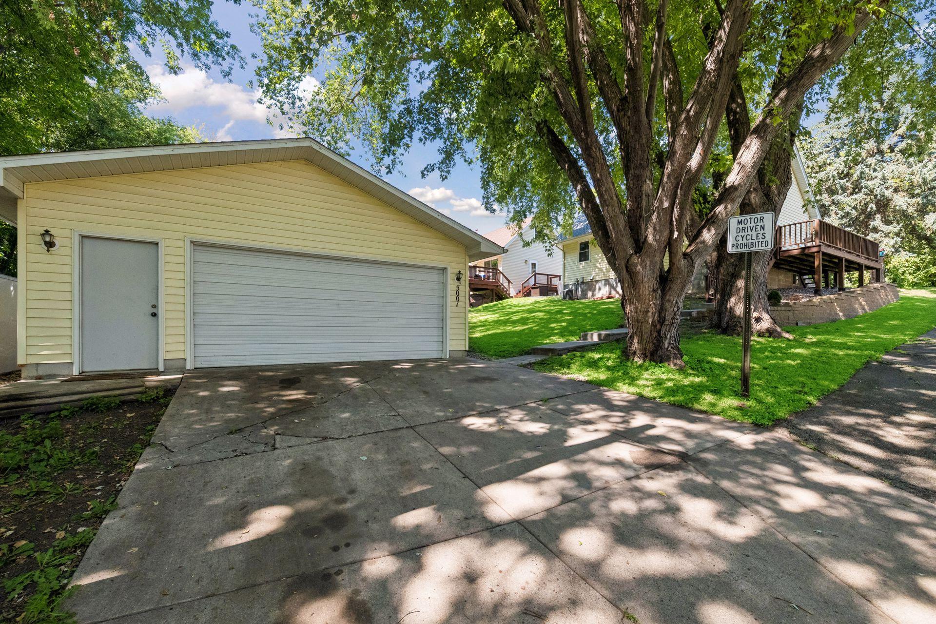 Detached oversized two car garage with concrete driveway