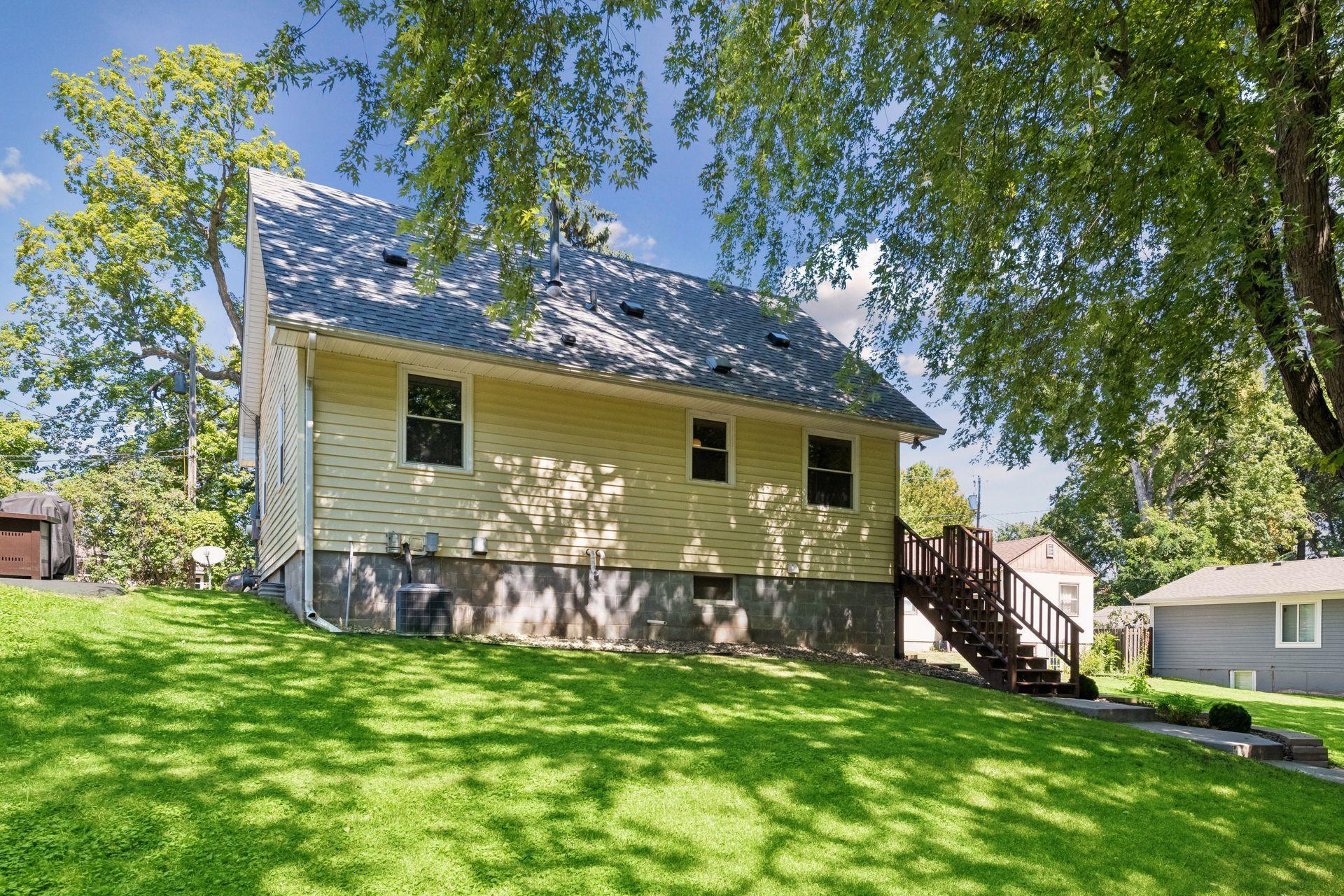 Back of home with slightly sloped backyard with plenty of space to entertain