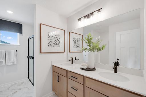 It's the little daily luxuries in life, like dual sinks, a large linen closet, and plenty of cabinet space! Photo of model home, finishes may vary.