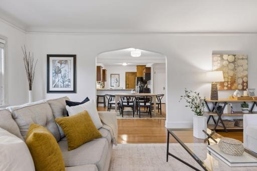 Upper unit - living room with graceful archway into dining room.