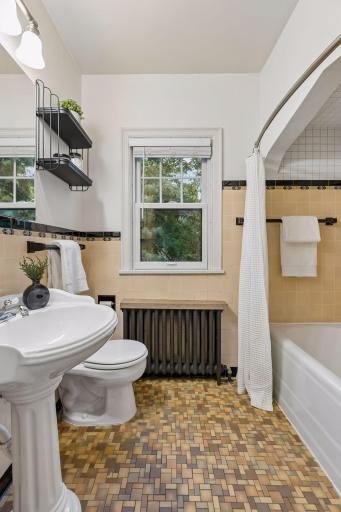 Upper unit - full bath with original tile.