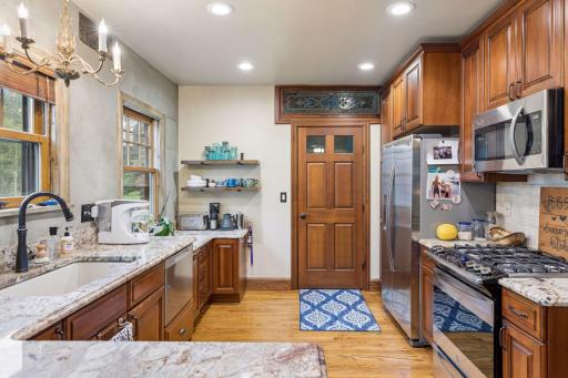 Main floor kitchen with stainless appliances and beautiful custom cabinetry.