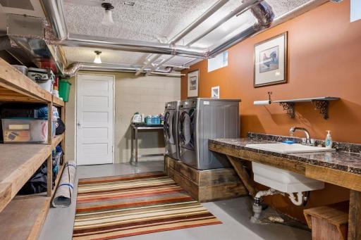 Lower level shared laundry with newer washer and dryer.