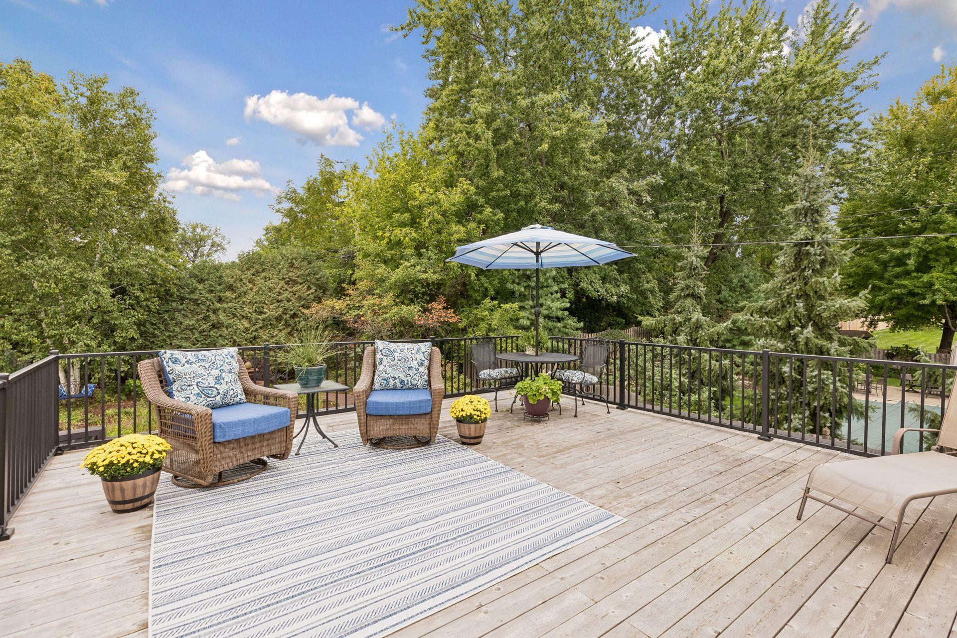 Huge shared deck over the 2 stall garage overlooking the beautiful perennial garden. Room for both seating and dining.