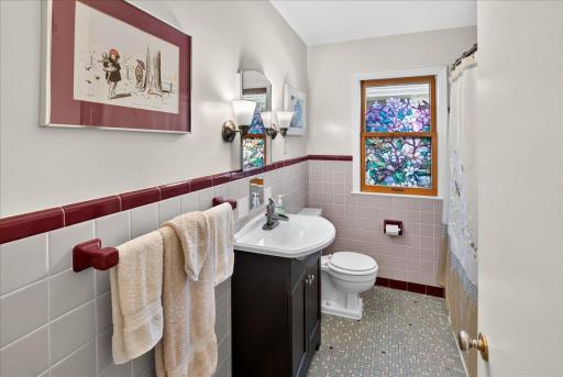 Main level full bathroom with original tile work.