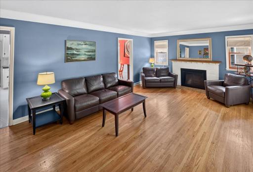 Living Room features original hardwood floors and wood burning fireplace.
