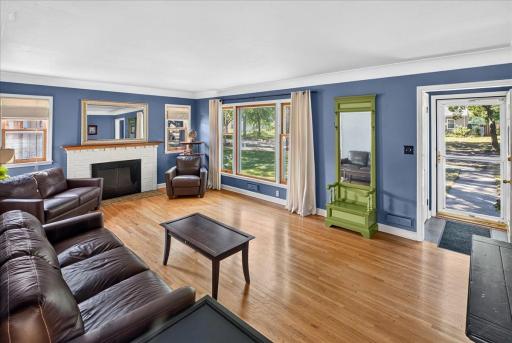 Spacious living room with hardwood floors and massive windows that flood the space with natural light.