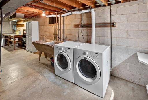 Lower level laundry area offers plenty of storage space.