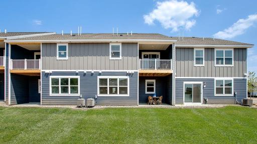 Enjoy private deck off the primary bedroom and a covered patio. Model photo. Options and colors will vary.