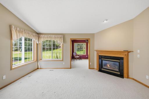 Living area of vaulted great room looking into lovely sun filled sitting room.