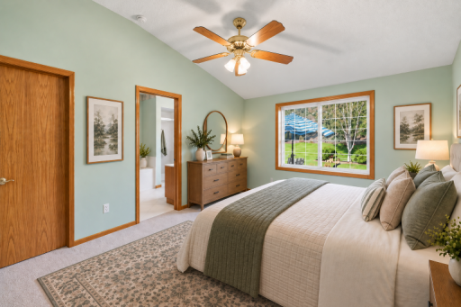 Primary with King bed and full ensuite bathroom - virtually staged.png