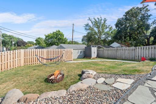 Large backyard with wood privacy fence.