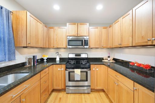 Under cabinet lighting Stainless Appliances and Cherry Wood Cabinits
