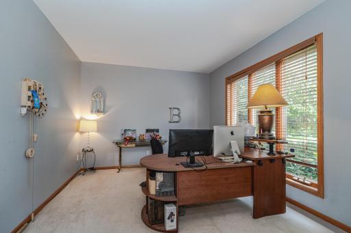 The office/study has large windows overlooking the front of the home. This space can be closed off with gridded French doors.