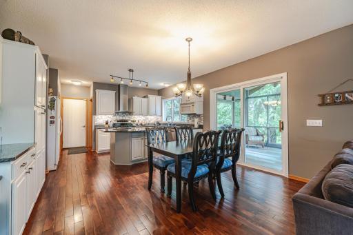 The kitchen is open to the screened porch behind the home.