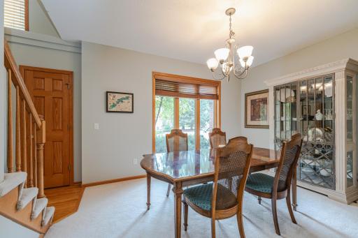 A dining room lies between the foyer and kitchen and has large windows.