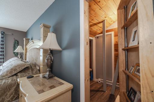 The bookcase swings open to reveal a secret room/hidden closet.