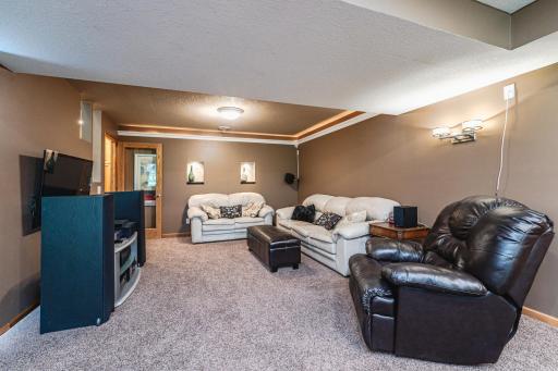 Tray vault lighting at sconces create an ambient setting for movie nights.