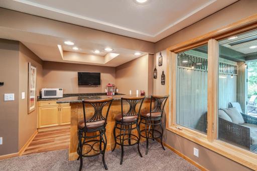 The bar has a box vault ceiling and recessed lighting.